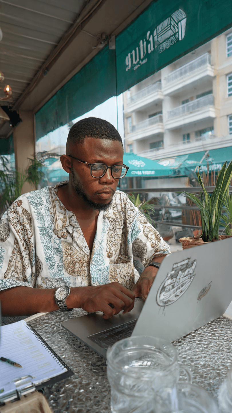 Remote worker enjoying coffee and productivity in a cafe in Abuja.